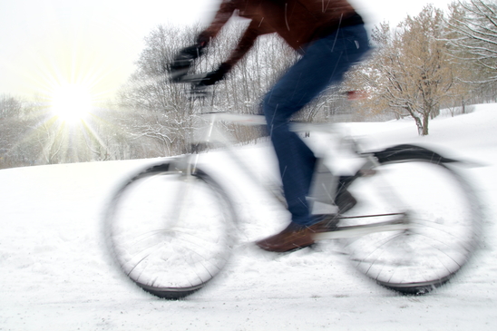 Dynamic cyclist with motion blur and winter sun